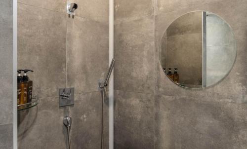 a bathroom with a shower and a mirror at Hotel 99 Prestige in Seoul