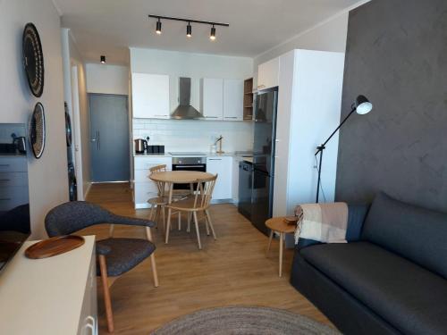 a living room and kitchen with a couch and a table at 211 The Meadows in George