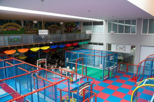 a large indoor play area with slides and rides at Hotel Saturday in Palma Campania