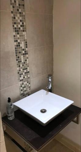 a white sink in a bathroom with a mirror at 284 - Room 6 - Beachfront in Swansea