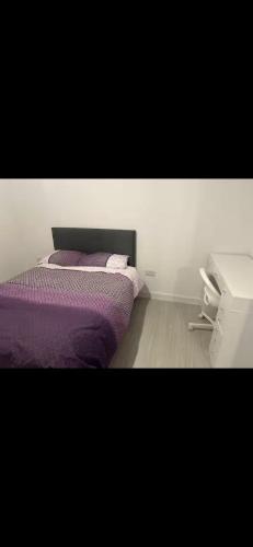 a bedroom with a purple bed and a phone at The Courtyard in Navan