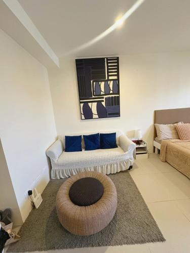 a living room with a couch and a rug at Serene Oaisis Condo with Netflix & WiFi in Davao City