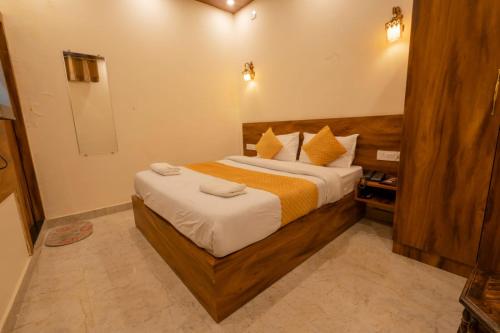a bedroom with a large bed in a room at Hotel Relax Inn Ganga Rishikesh in Rishīkesh