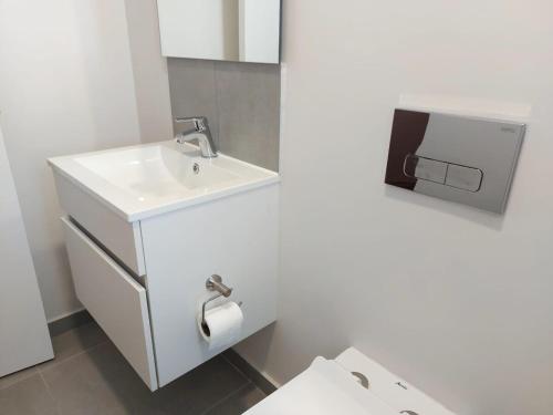 a white bathroom with a sink and a toilet at 212 The Meadows in George