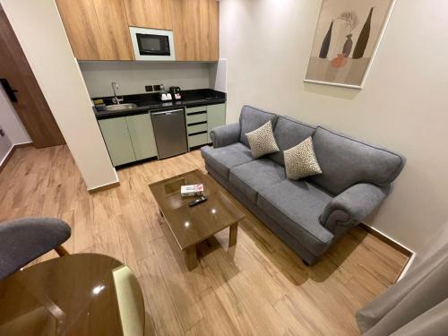 a living room with a couch and a table at Alfa Residence in Cairo
