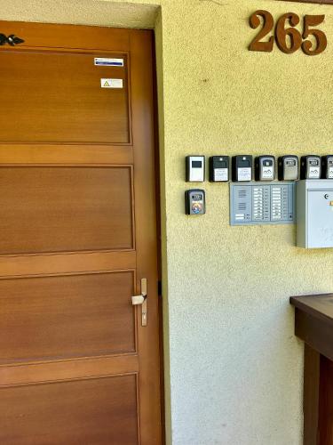 a door in a room with clocks on the wall at Apartment Tatry Comfort - Tatranská Lomnica in Vysoké Tatry