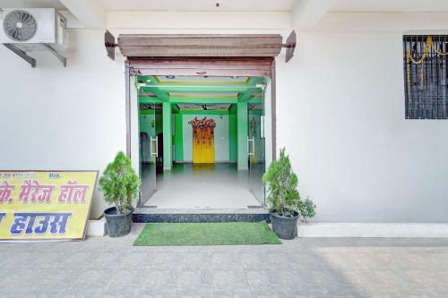 an entrance to a building with a yellow door at Super Hotel O R K Marriage Hall and Guest House in Patna