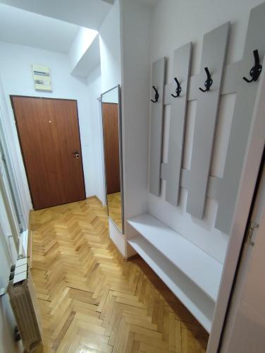 a hallway with white walls and a wooden floor at Gigabit High-Speed Internet Modern Apartment in Skopje