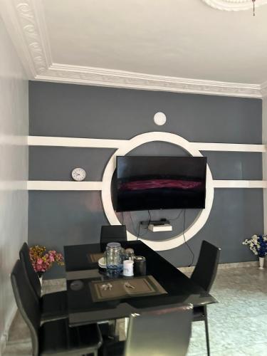 a dining room with a table and a mirror at ADISSA's PLACE in Cotonou