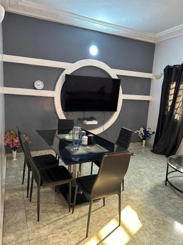 a dining room with a black table and chairs at ADISSA's PLACE in Cotonou