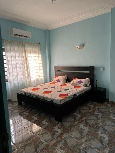 a bedroom with a bed in a room at ADISSA's PLACE in Cotonou