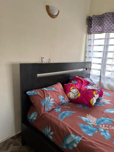a bed with two pillows on top of it at ADISSA's PLACE in Cotonou