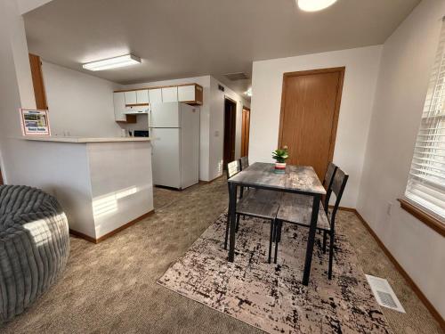 a living room with a table and a kitchen at Huckleberry's Hideaway in Boise