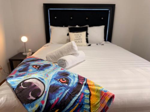 a bed with a picture of a dog on it at Huckleberry's Hideaway in Boise