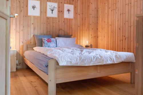 a bedroom with a bed in a wooden wall at Val d'Illiez, 6 pers - balcon et vue - parking in Val dʼIlliez