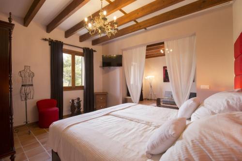 a bedroom with a large white bed and a chandelier at Elegant Dream Home in Consell City, 1021 in Consell