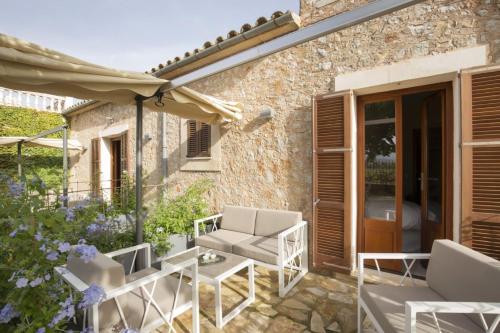 a patio of a house with chairs and an umbrella at Elegant Dream Home in Consell City, 1021 in Consell