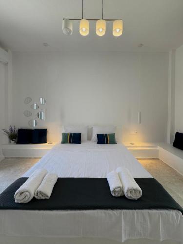 a bedroom with a large bed with two towels on it at AGAPI apartments in Kithnos