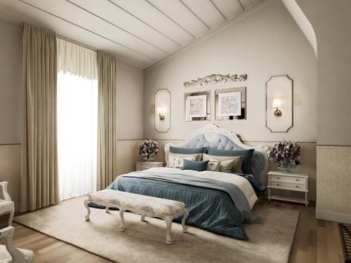 a bedroom with a blue bed and a large window at Pacheca The Wine House Hotel e Spa - Quinta da Pacheca in Lamego