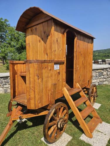 an old wooden wagon sitting in the grass at Vinica Castle Boutique & Spa Hotel in Vinica