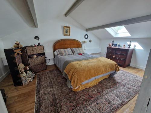 a bedroom with a bed and a dresser at My lilifab in Saint-Saud-Lacoussière