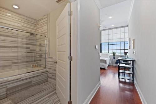 a bathroom with a walk in shower next to a bedroom at XL Studio - Luxury Studio Near Center City in Philadelphia