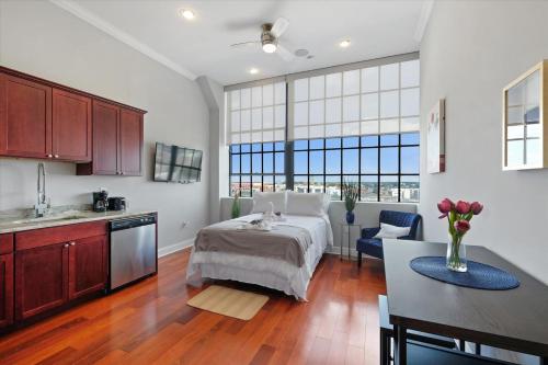 a kitchen and a bedroom with a bed and a table at XL Studio - Luxury Studio Near Center City in Philadelphia