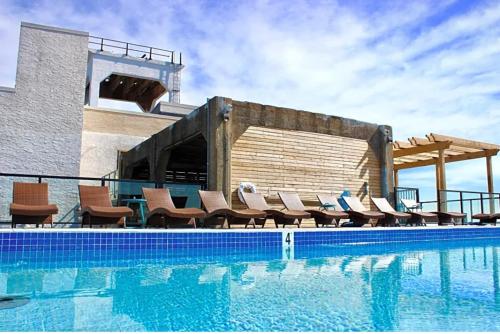 a swimming pool with chairs next to a building at XL Studio - Luxury Studio Near Center City in Philadelphia