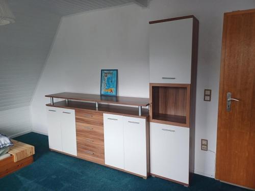 a room with white cabinets and a wooden door at Vacation home Albersloh close to Münster in Sendenhorst