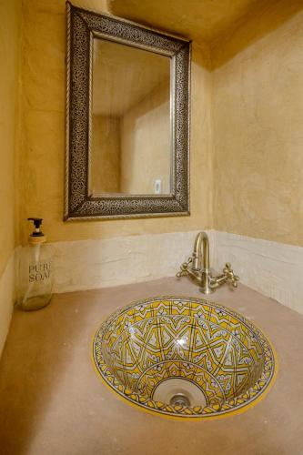a bathroom sink with a mirror on the wall at Hostal Nazarí in Cogollos De La Vega