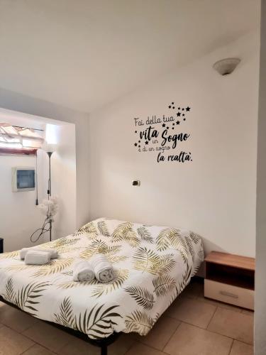 a bedroom with a bed with a poster on the wall at La Casa Dei Sogni in Gallico