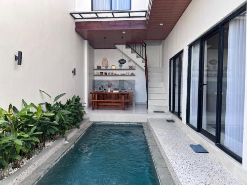 a swimming pool in the middle of a house at 3 Bedrooms Private Villa & Pool Near GWK-ER House in Jimbaran