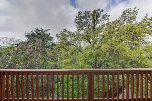 a wooden fence with trees in the background at Vacation Home with Whole Home Air Cleaner and Jacuzzi in Austin