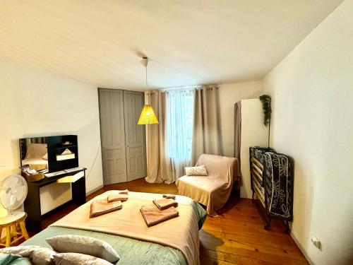 a bedroom with two beds and a refrigerator at Apartment La Viarhôna à Brégnier-Cordon in Brégnier-Cordon