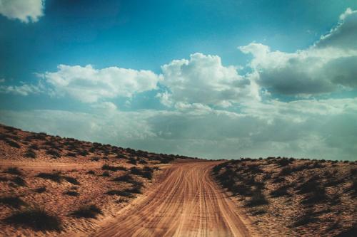 a dirt road in the middle of the desert at Safari Desert Camp in Shāhiq