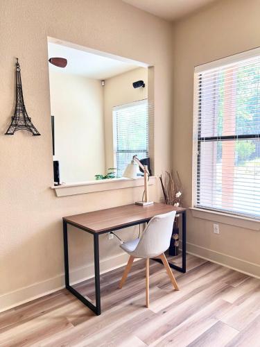 a desk and a chair in a room with a mirror at Vacation Home with Whole Home Air Cleaner and Jacuzzi in Austin