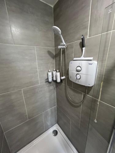 a bathroom with a shower with a shower head at Number20 in Castleblayney