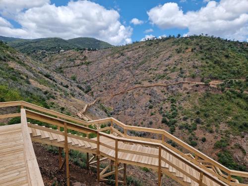 a wooden stairway leading up to a mountain at Casa Spa d'Alma in Monchique