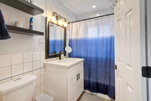 a white bathroom with a sink and a mirror at Seabreeze 1BR, Walk to Sand, Pet Friendly, Parking, Fire Pit Access in Carlsbad