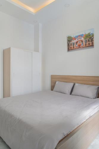 a bedroom with a large bed with white sheets at Soul Station - Studio Hotel II in Ho Chi Minh City