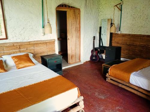 Postel nebo postele na pokoji v ubytování Cabañas rurales Arabi