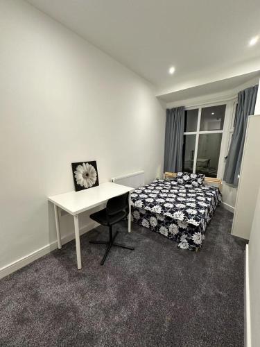 a bedroom with a bed and a desk and a table at City Stays at St Patricks - Private Ensuites in Coventry