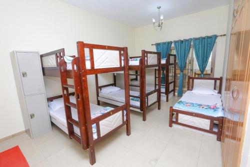 a group of bunk beds in a room at Sarjak Hostel in Dubai