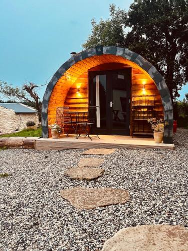 a small dome house with a table and chairs in it at Welcome to the pod in Balnacart
