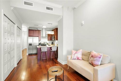 a living room with a couch and a kitchen at XL Studio - Studio with Pool & Scenic Rooftop in Philadelphia