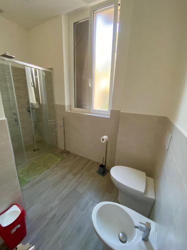 a bathroom with a toilet and a shower and a sink at Marine Residence in Albisola Superiore