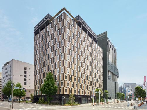 a rendering of a tall building in a city at Mitsui Garden Hotel Fukuoka Gion in Fukuoka