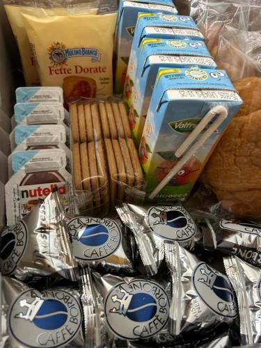 a pile of cookies and pastries and other packaged food at Dimore Cedracca in Matera