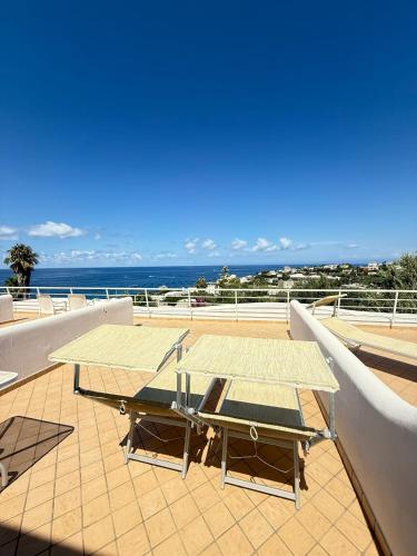 a table on a roof with a view of the ocean at Hotel Albatros in Ischia