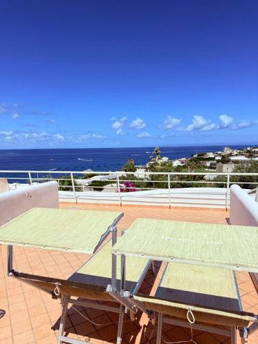 two tables on a balcony with the ocean in the background at Hotel Albatros in Ischia
